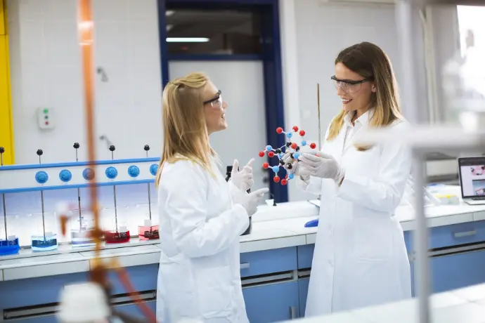 Chemists hold a molecular model in the laboratory