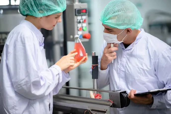 food technician monitoring the drinking water production line in the manufacturing plant