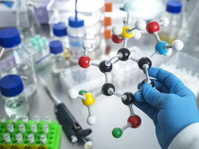 Scientist holding a molecular model in the laboratory